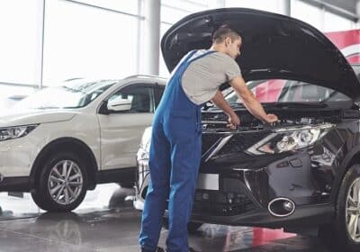 muscular-car-service-worker-repairing-vehicle