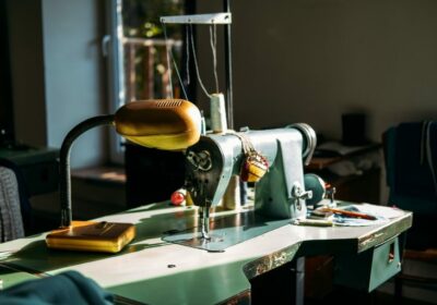 sewing-machine-on-table-in-factory-in-sun-light-small-business-fashion-designe-tailor-working-768×512-1