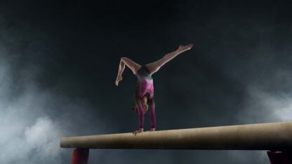 female-gymnast-doing-complicated-trick-gymnastics-balance-beam-professional-arena
