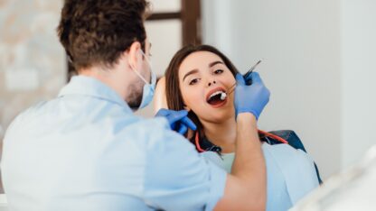 dentist-making-professional-teeth-cleaning-withb-cotton-female-young-patient-dental-office-1